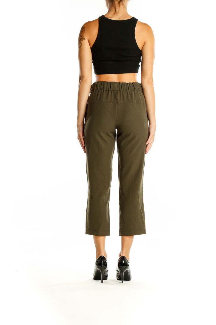 Back view of olive green Lululemon cropped activewear pants on model