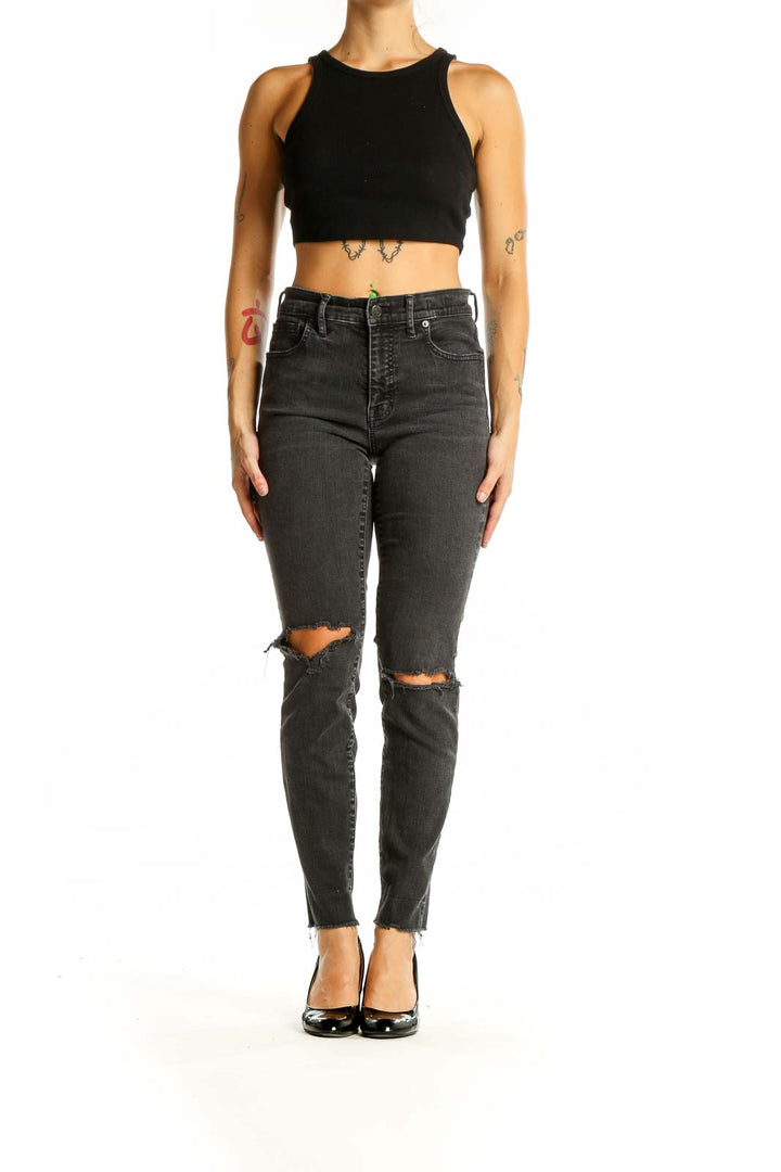 Front view of Madewell charcoal high-waisted skinny jeans with distressed knees