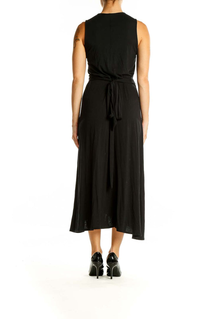 Back view of black Gap midi wrap dress showing tie waist