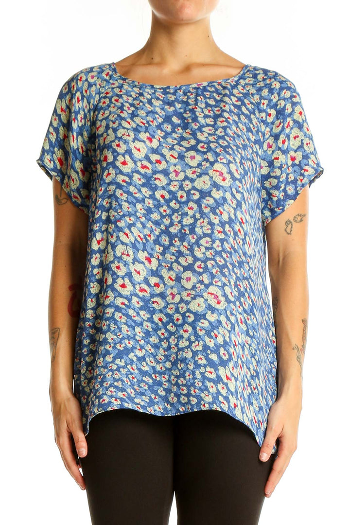 Front view of Cabi blue floral print short sleeve blouse on model