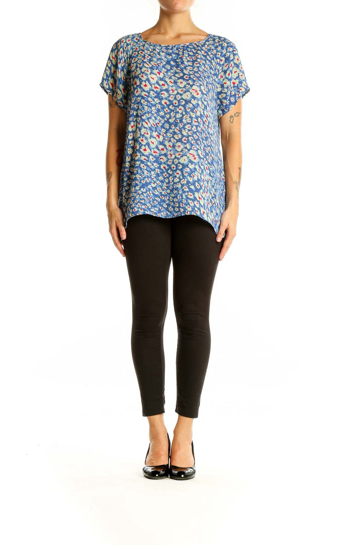 Front view of Cabi blue floral print short sleeve blouse on model