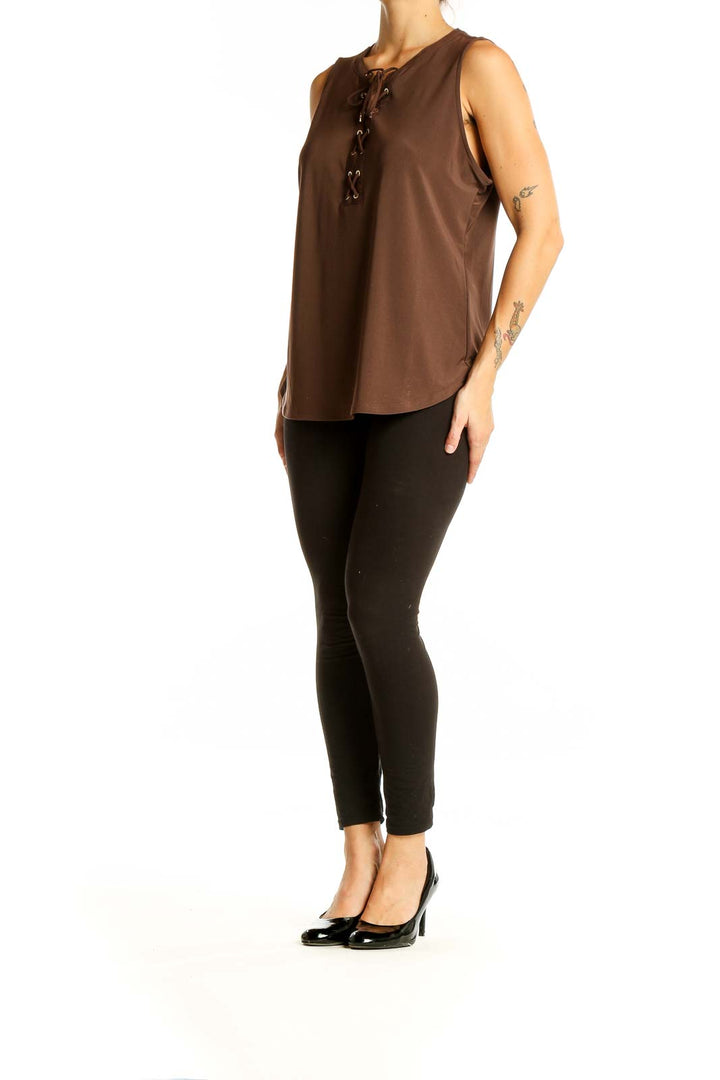 Front view of brown sleeveless blouse with lace-up neckline