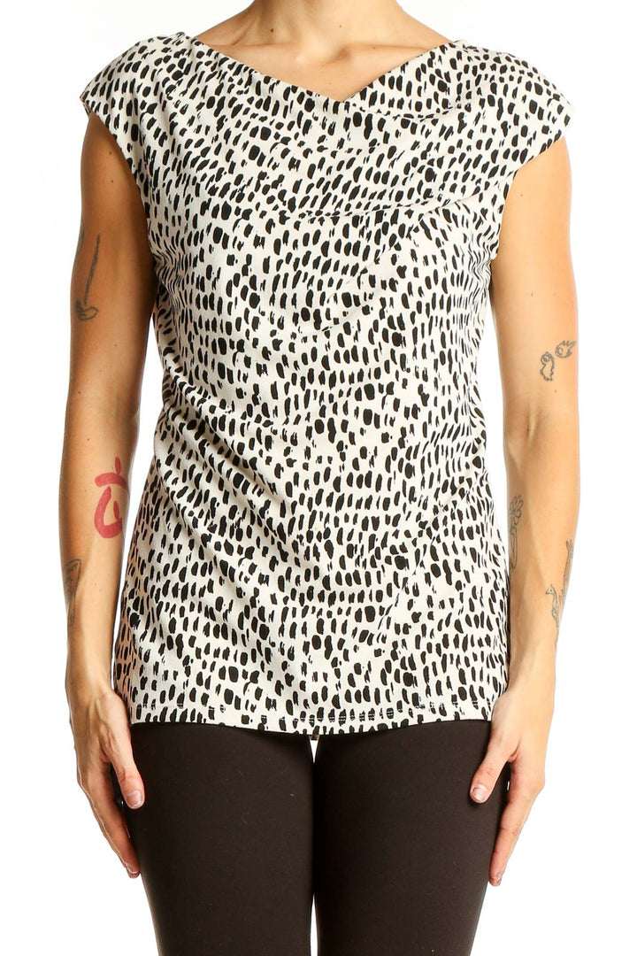 Front view of Ann Taylor black and white spotted cap sleeve top