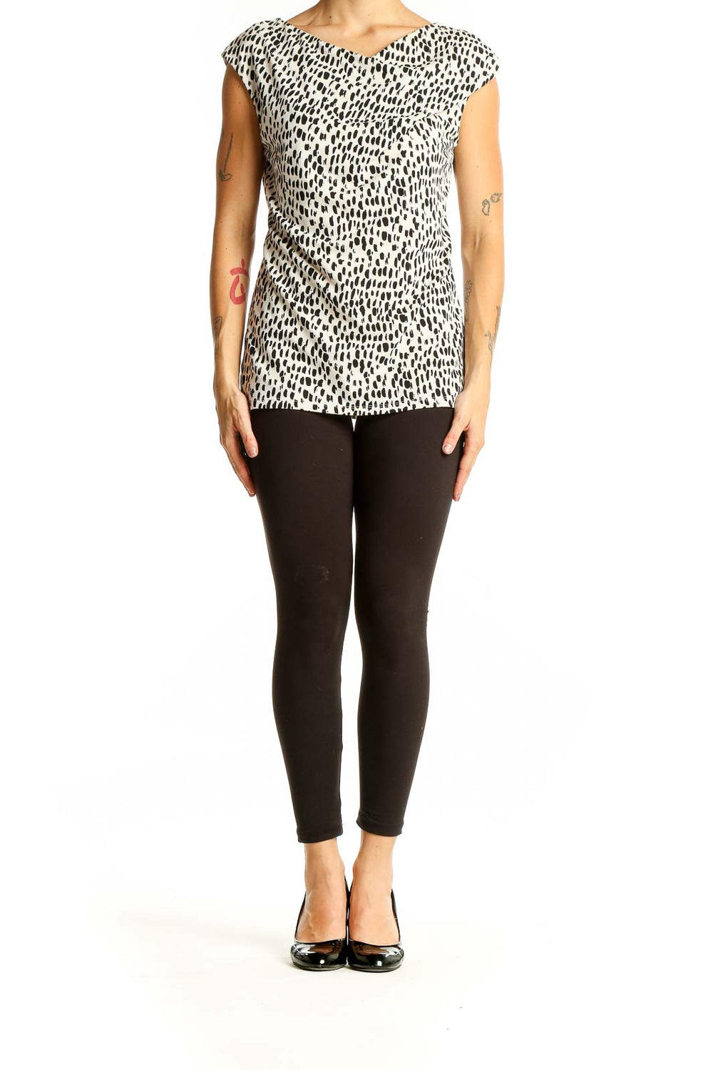 Front view of Ann Taylor black and white spotted cap sleeve top