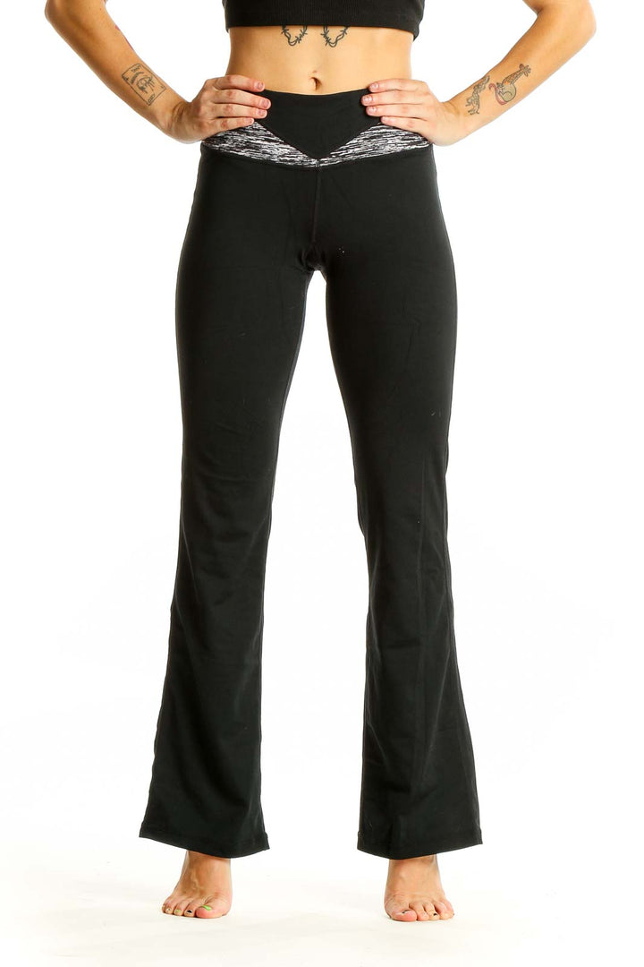 Front view of black Cabi flared yoga pants with heathered waistband