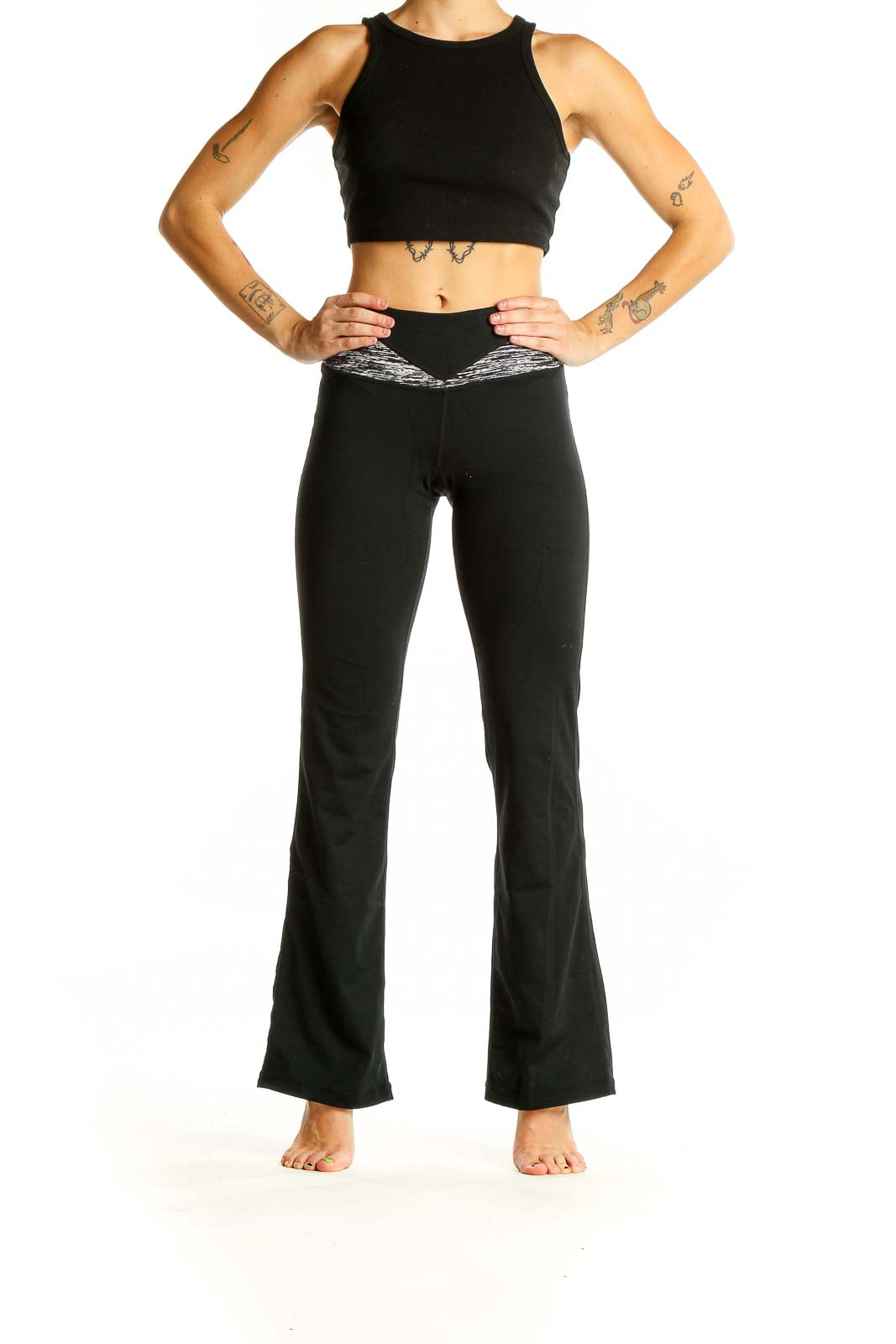 Front view of black Cabi flared yoga pants with heathered waistband