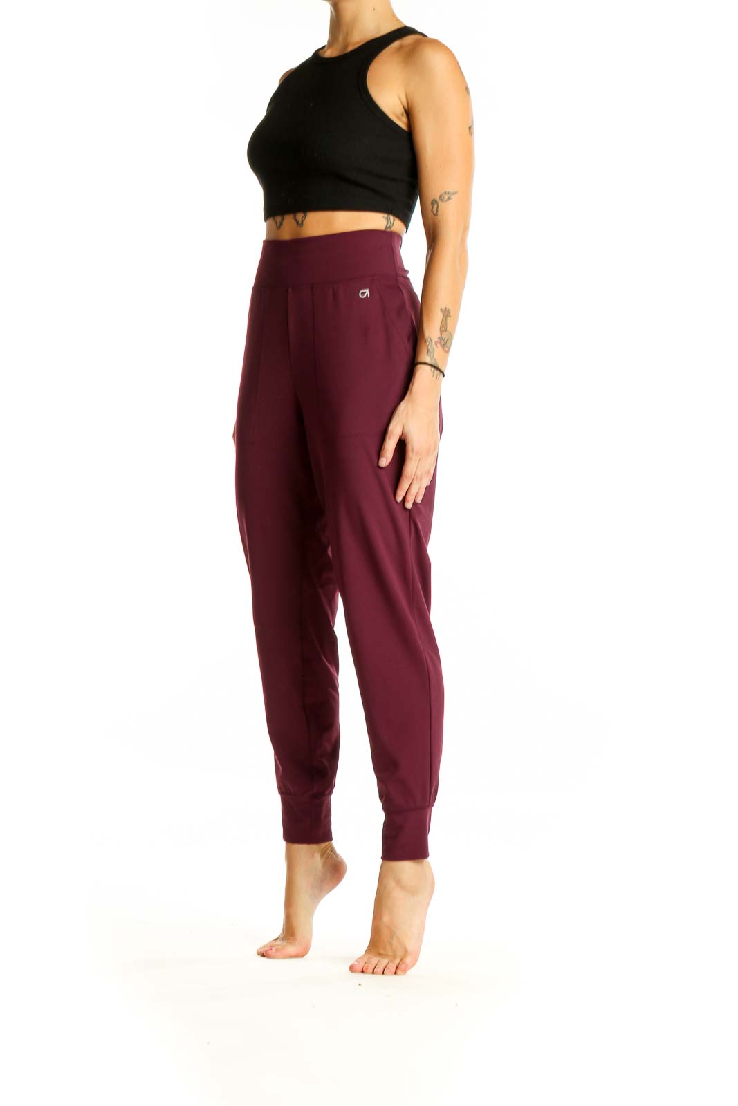 Front view of burgundy GapFit high-waisted jogger pants on model