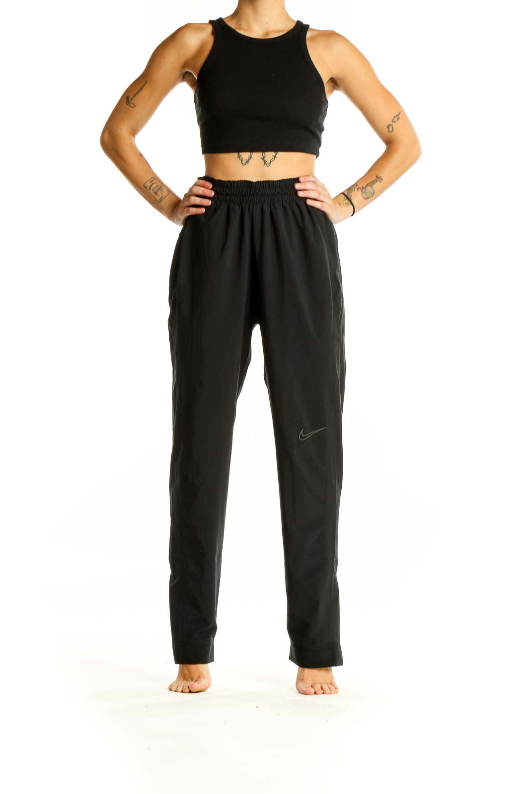 Front view of black Nike activewear pants with elastic waistband