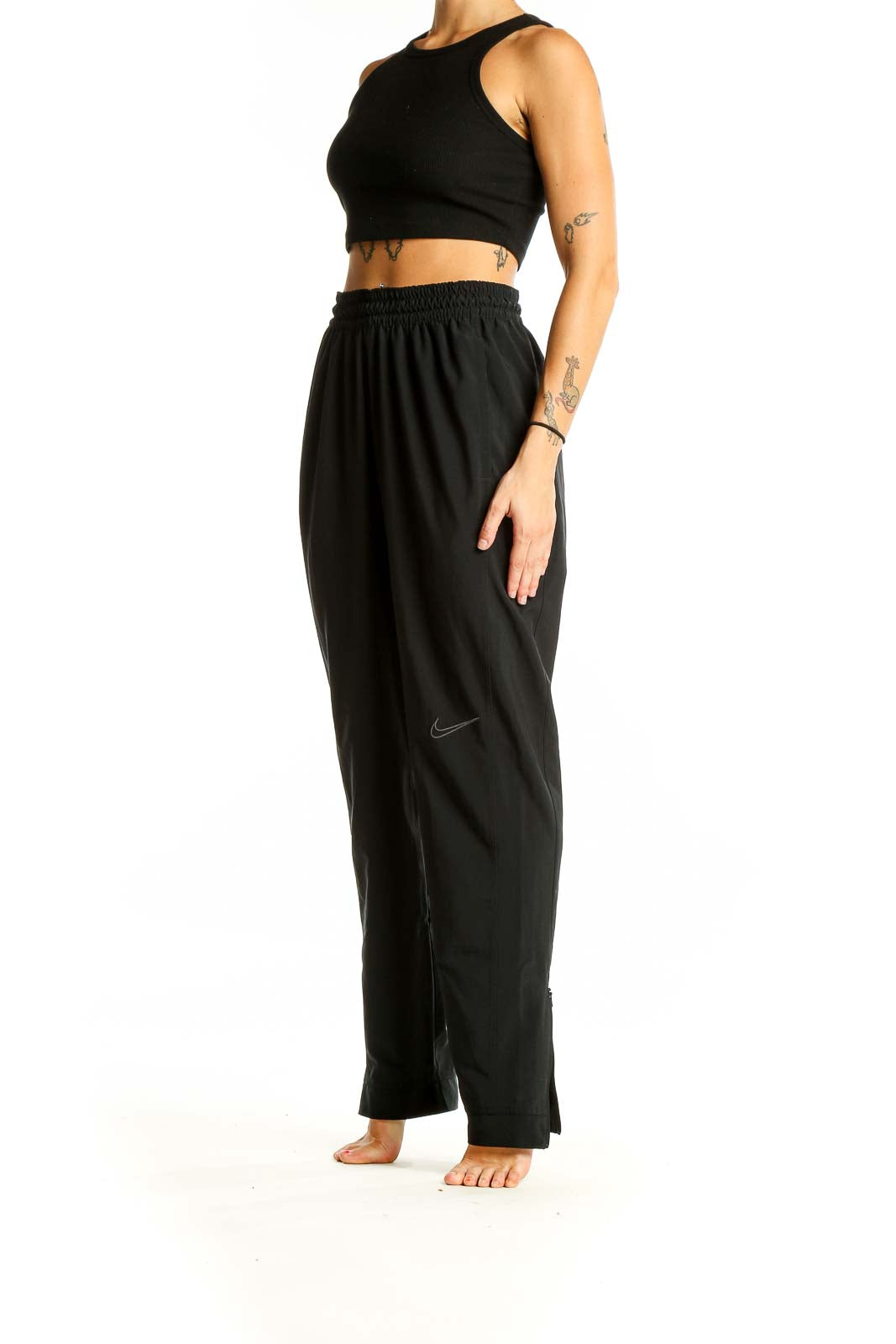 Front view of black Nike activewear pants with elastic waistband