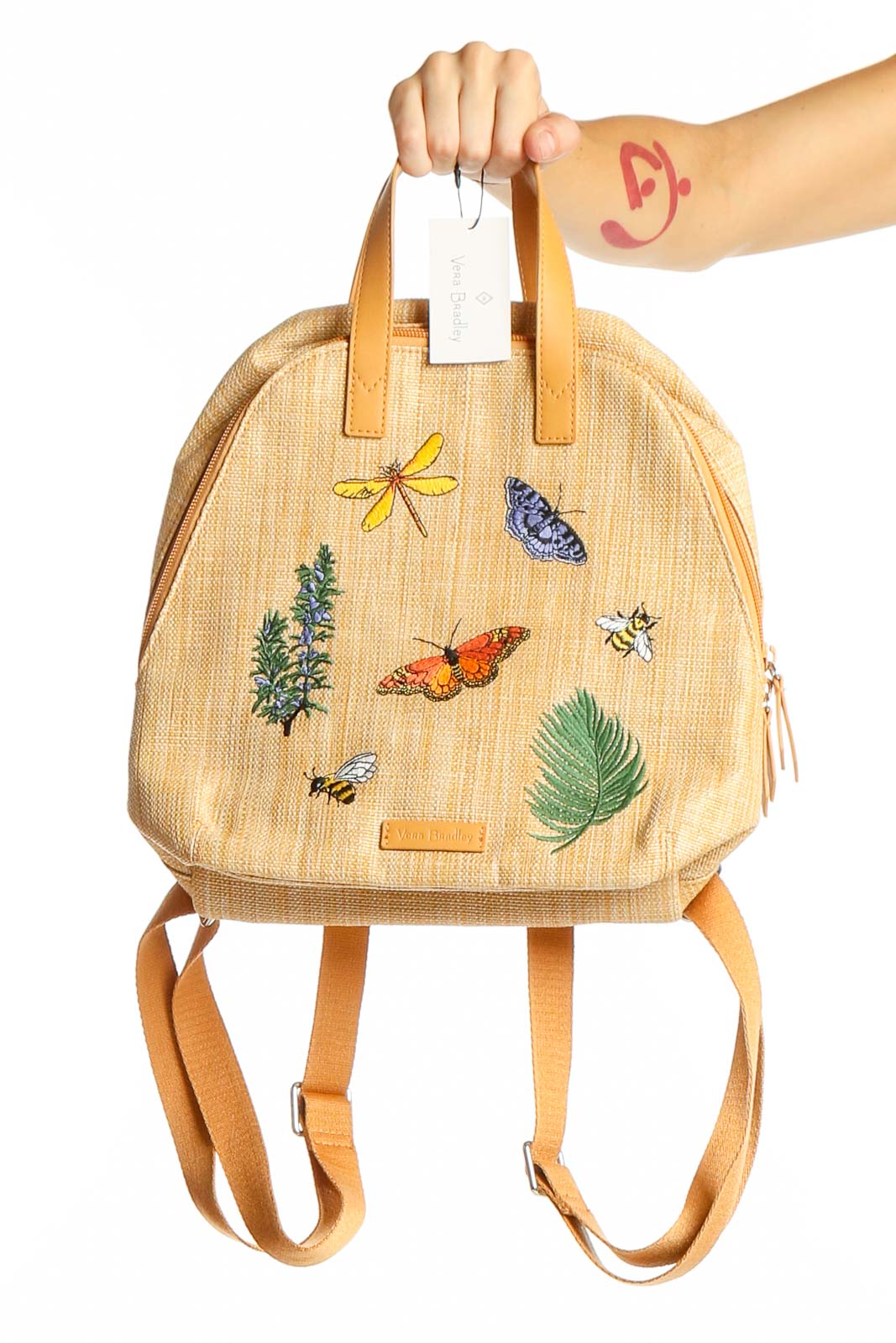 Beige Vera Bradley backpack with colorful embroidered butterflies and nature designs