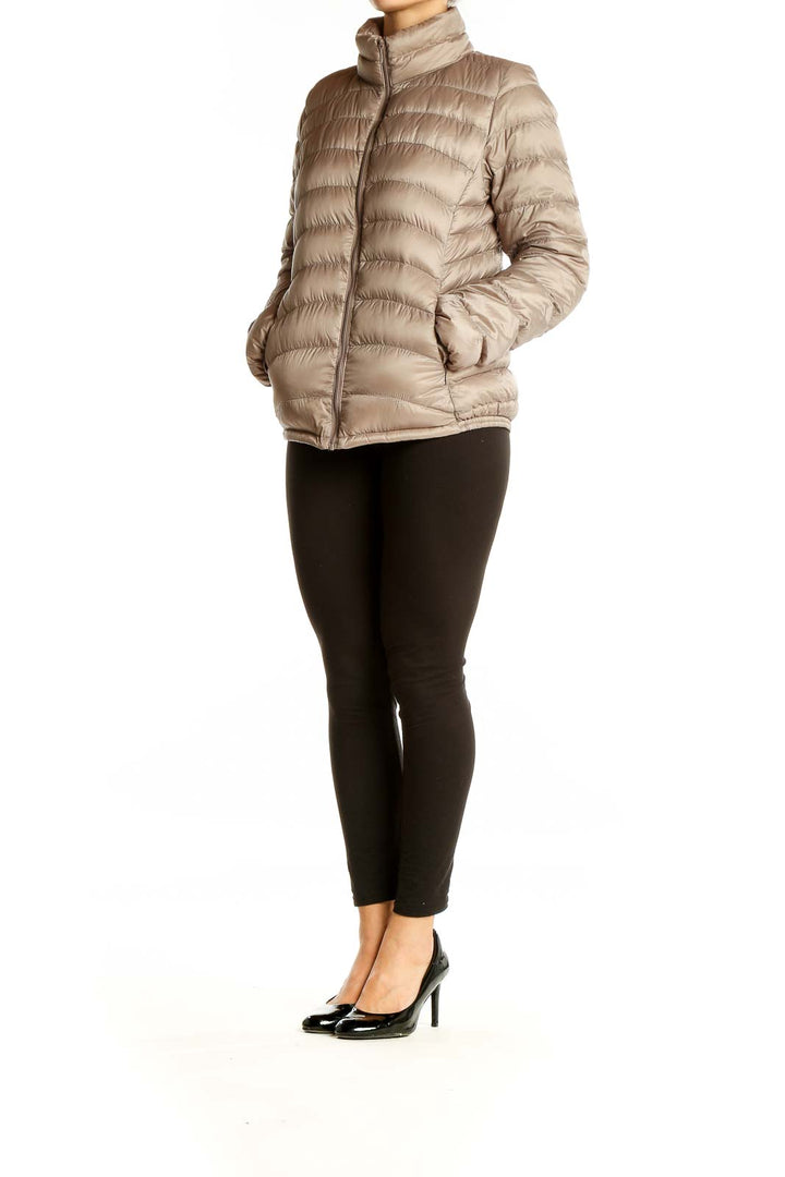 Front view of Uniqlo beige quilted puffer jacket