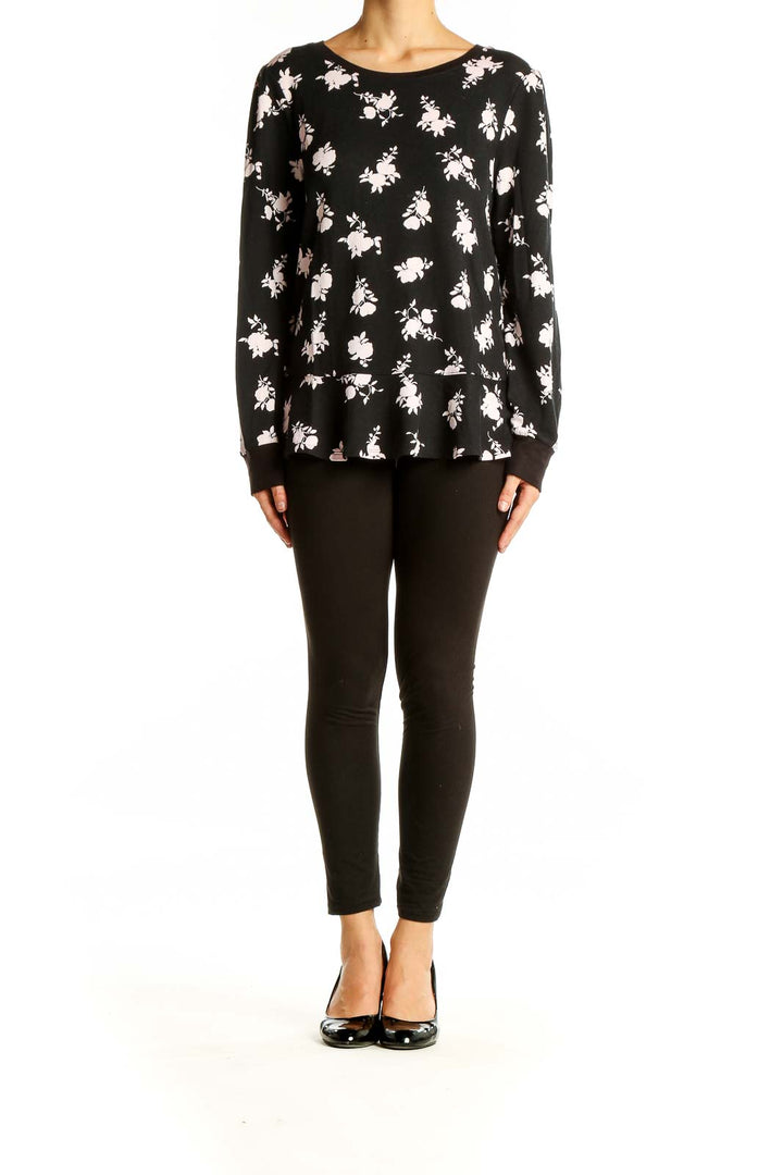 Front view of Kate Spade black floral print long sleeve top with peplum hem