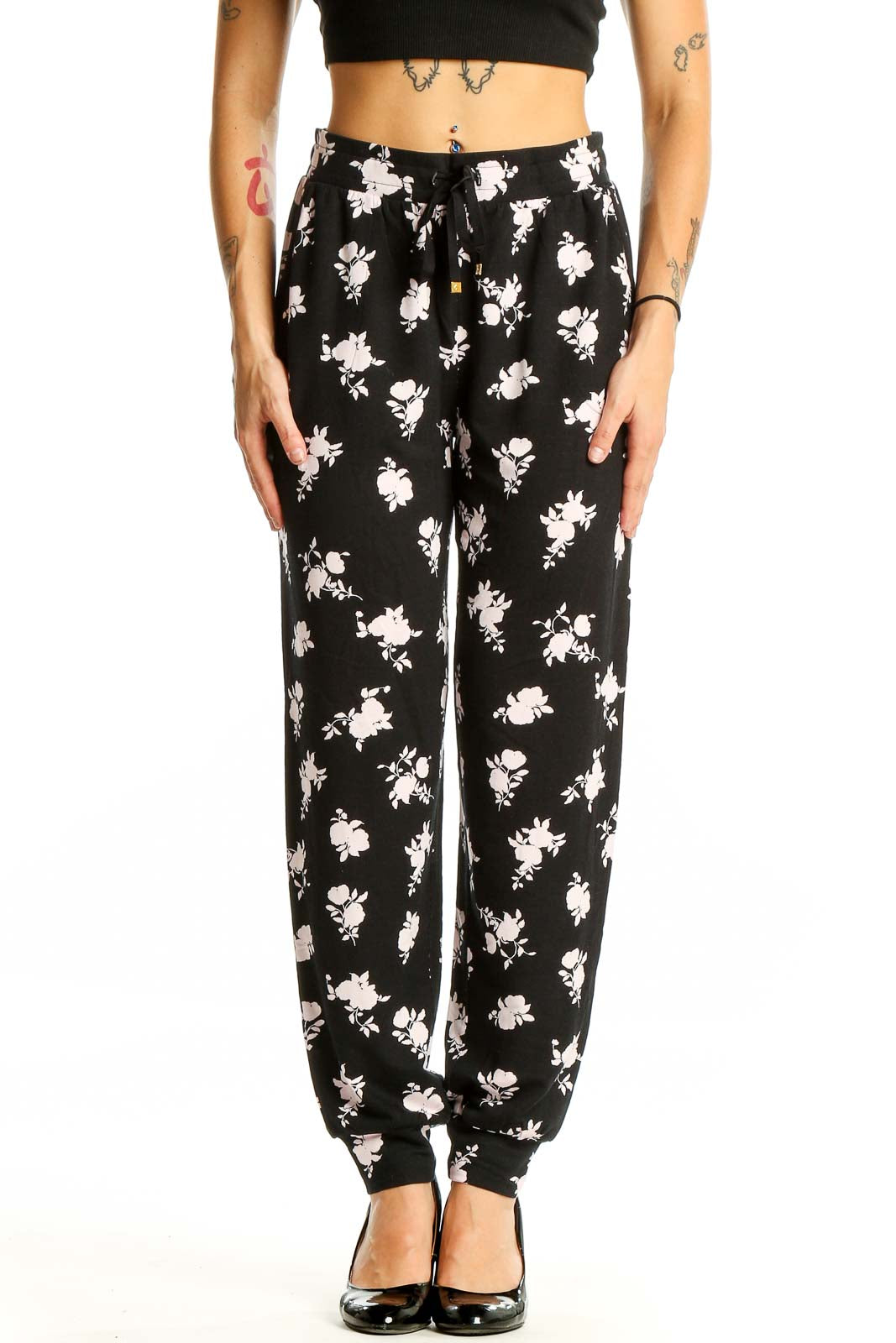 Front view of Kate Spade black pants with white floral print and drawstring waist