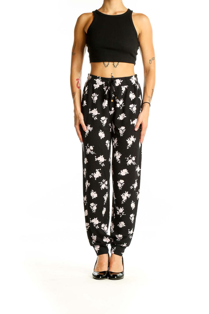 Front view of Kate Spade black pants with white floral print and drawstring waist