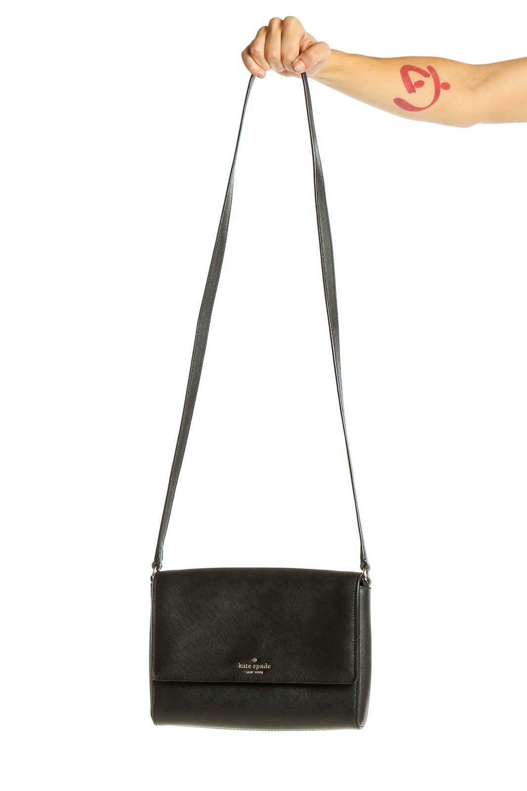 Front view of Kate Spade black leather crossbody bag with adjustable strap