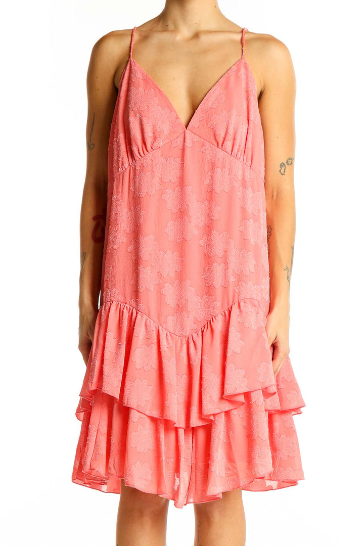 Front view of coral SilkRoll sundress with V-neck and tiered ruffle hem