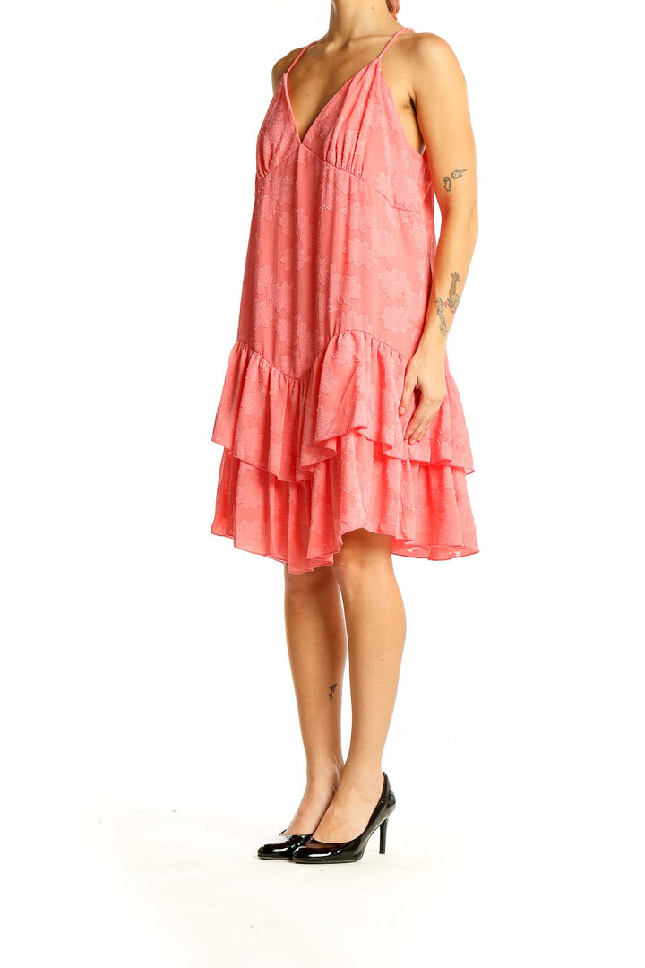 Front view of coral SilkRoll sundress with V-neck and tiered ruffle hem