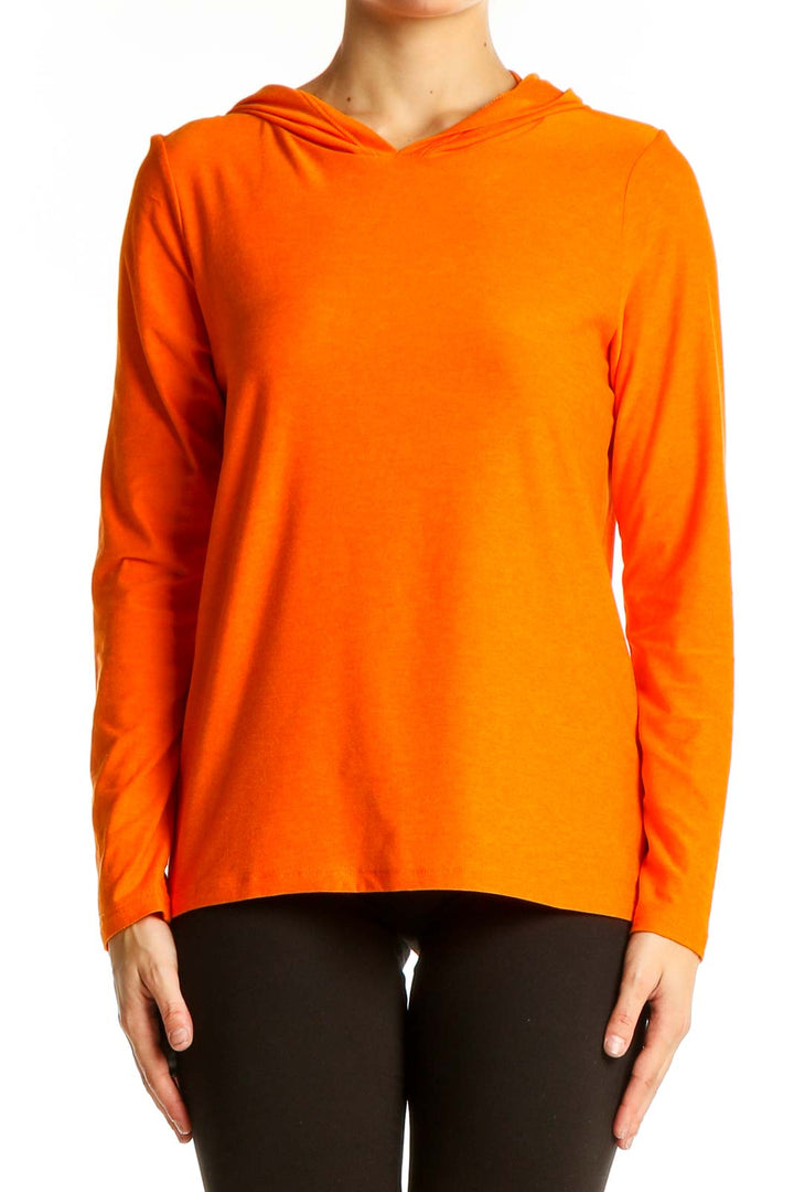 Front view of orange hooded long sleeve activewear top from Beyond Yoga