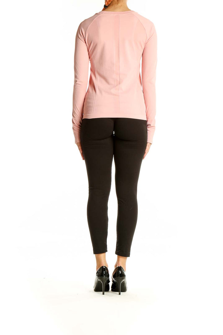 Back view of pink long sleeve athletic top by SilkRoll