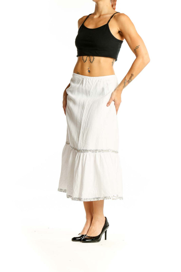 Front view of LOFT white linen tiered midi skirt with lace trim