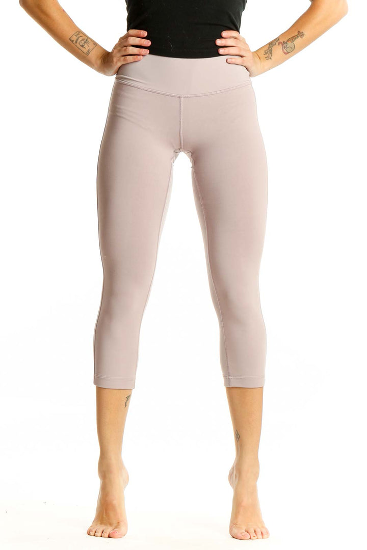 Front view of beige Lululemon high-waisted capri leggings