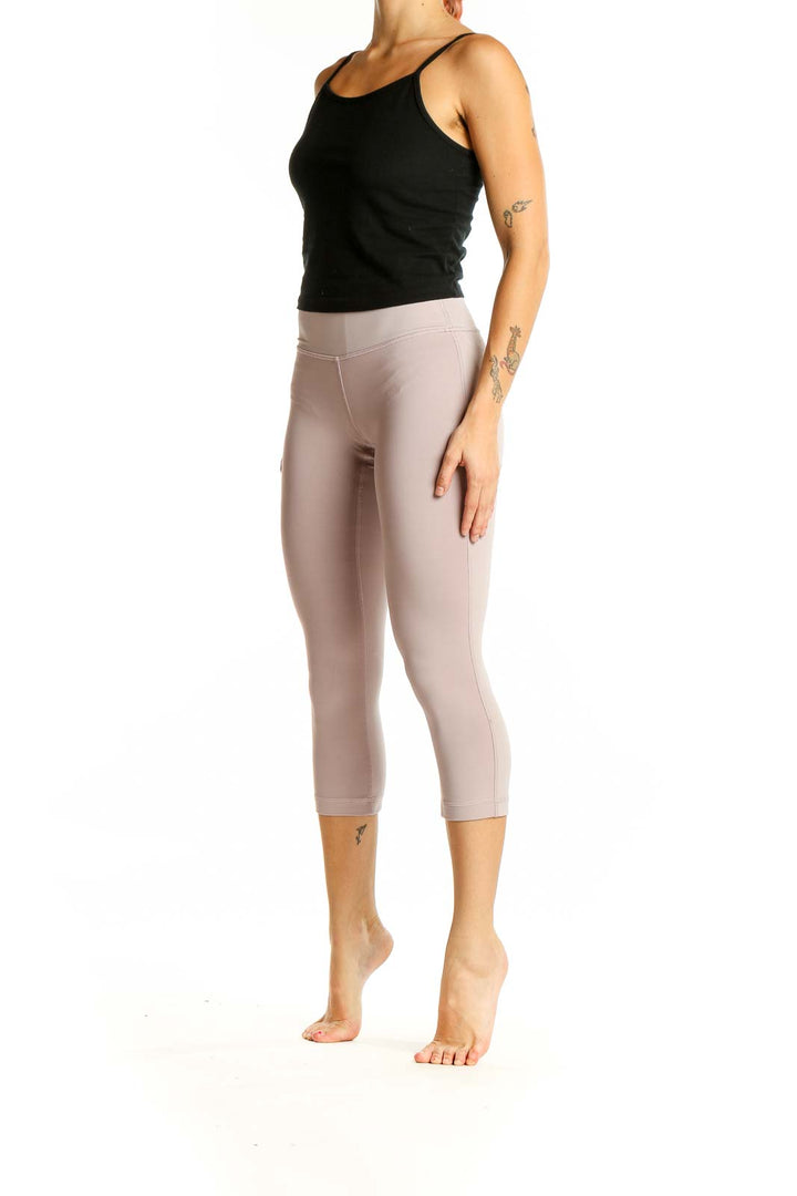 Front view of beige Lululemon high-waisted capri leggings