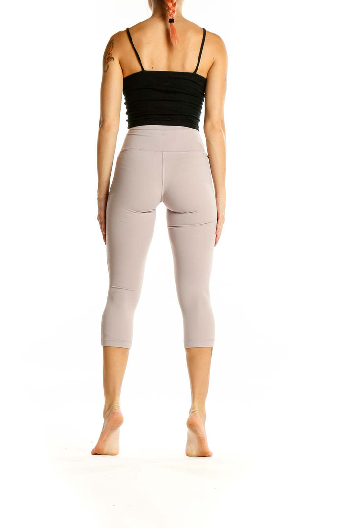 Back view of beige Lululemon high-waisted capri leggings