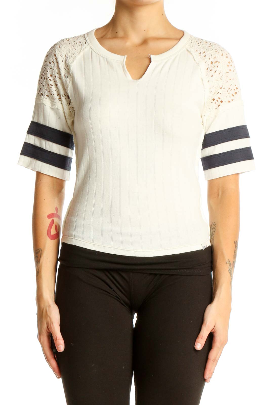 Front view of white BDG top with lace sleeves and black striped details