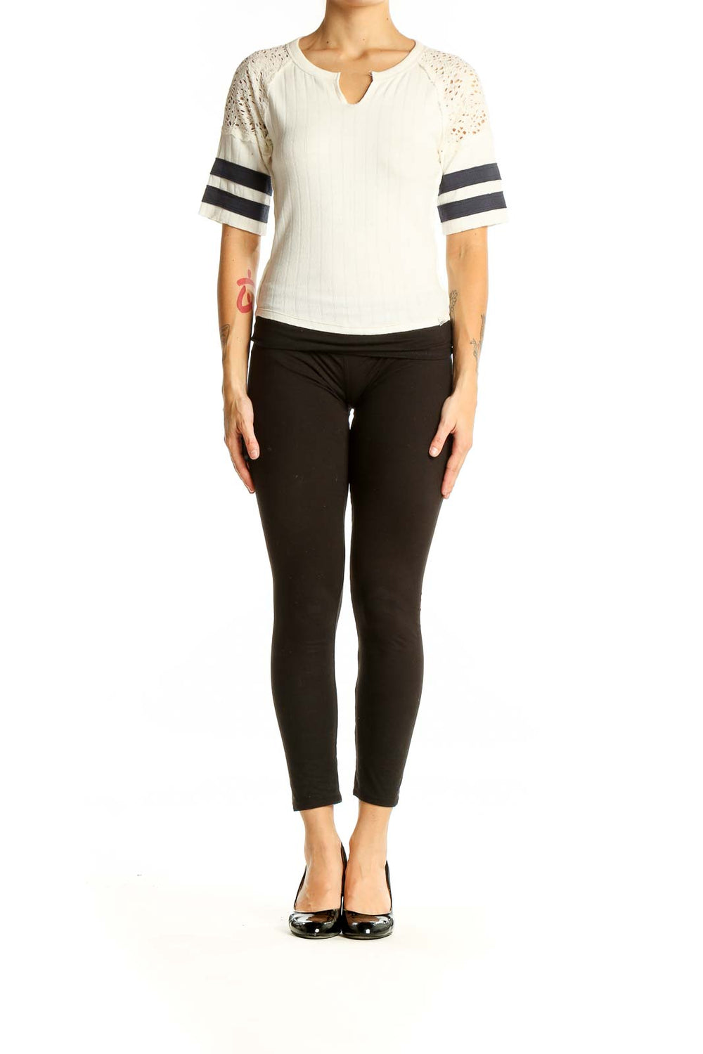 Front view of white BDG top with lace sleeves and black striped details