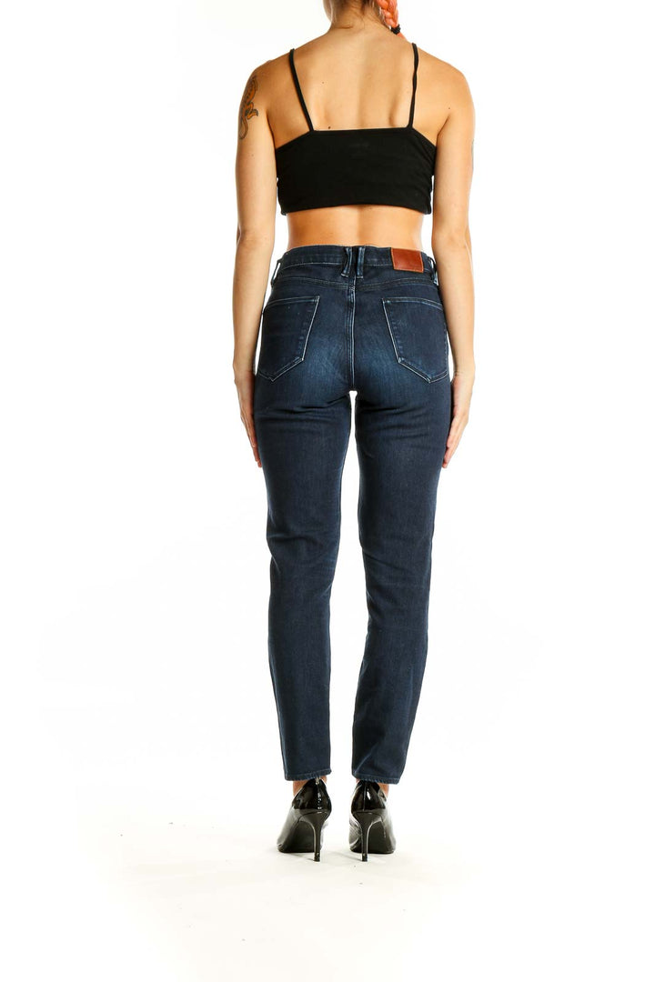 Back view of Madewell dark blue straight leg jeans on model