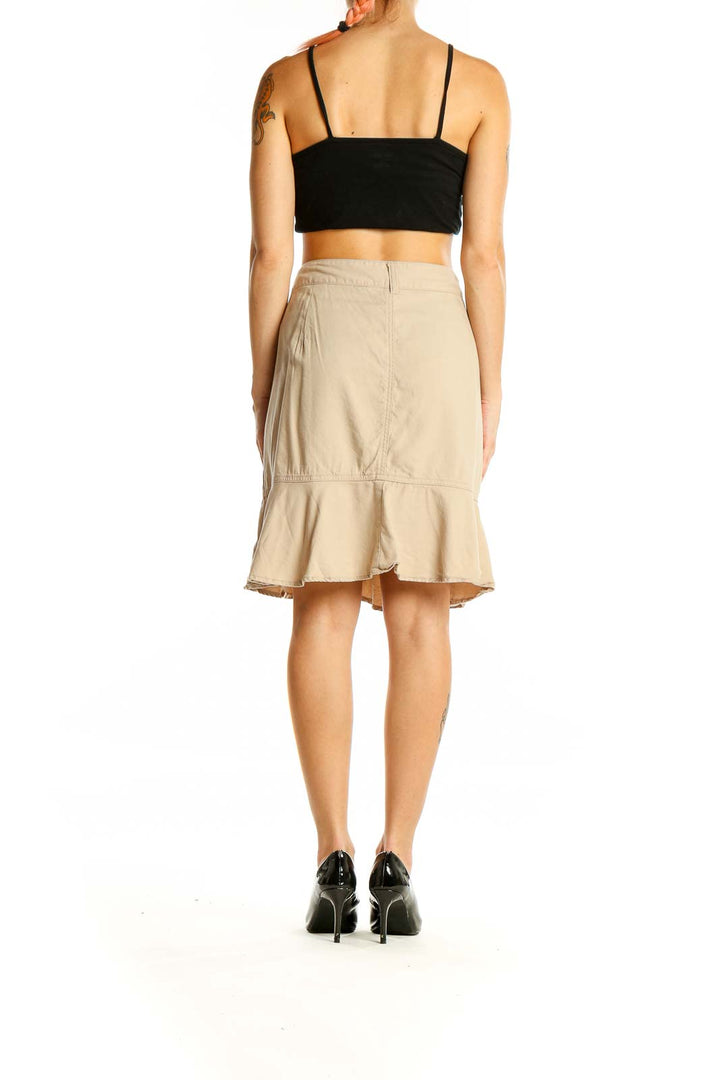 Back view of Nine West beige skirt showing flounce hem detail