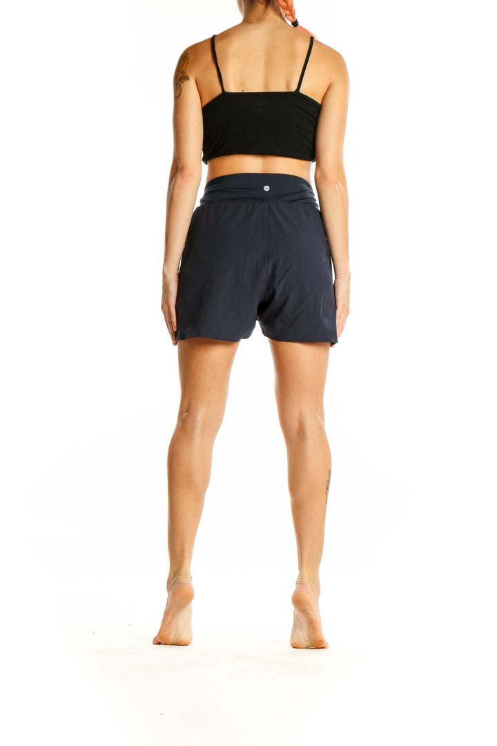 Back view of Avia navy high-waisted athletic shorts on model