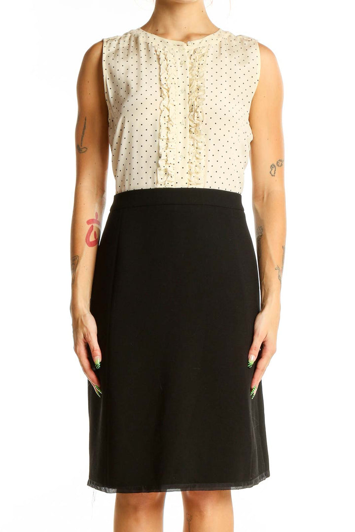 Front view of J.Crew cream polka dot sleeveless dress with black skirt