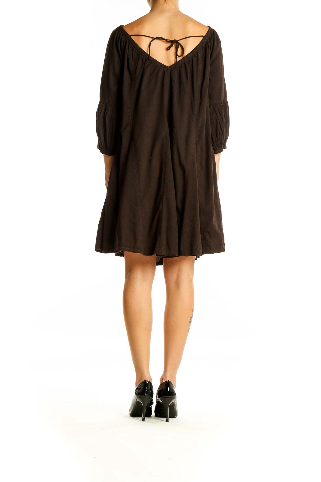 Back view of brown flowy peasant mini dress with tie detail by Daily Practice by Anthropologie