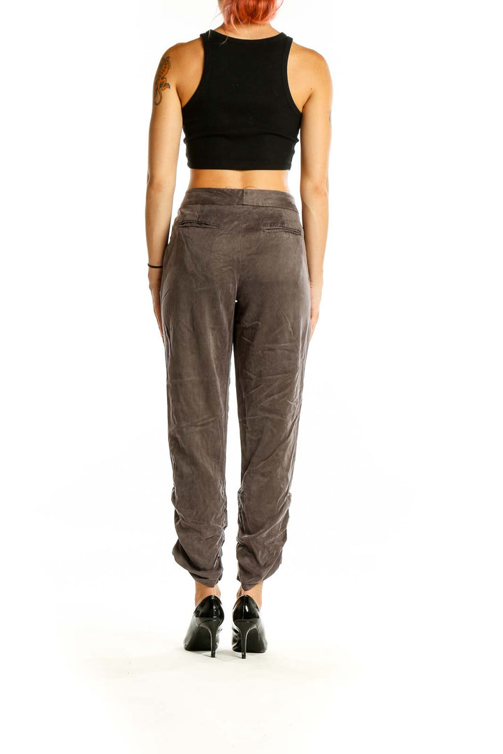 Back view of taupe relaxed fit jogger pants by Daughters of the Liberation