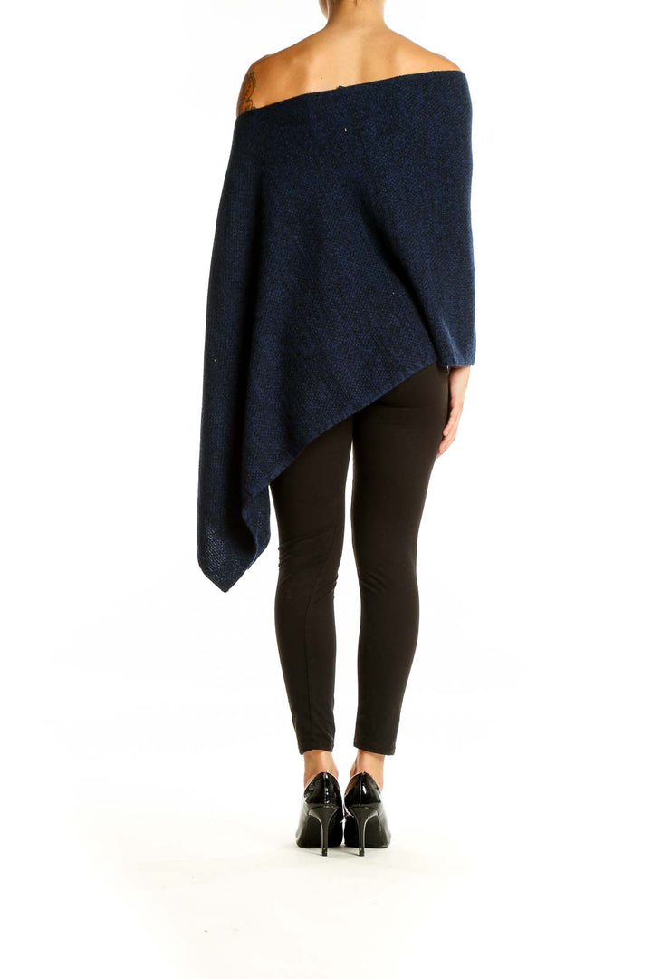 Back view of Magaschoni New York navy blue off-shoulder knit poncho showing asymmetric design