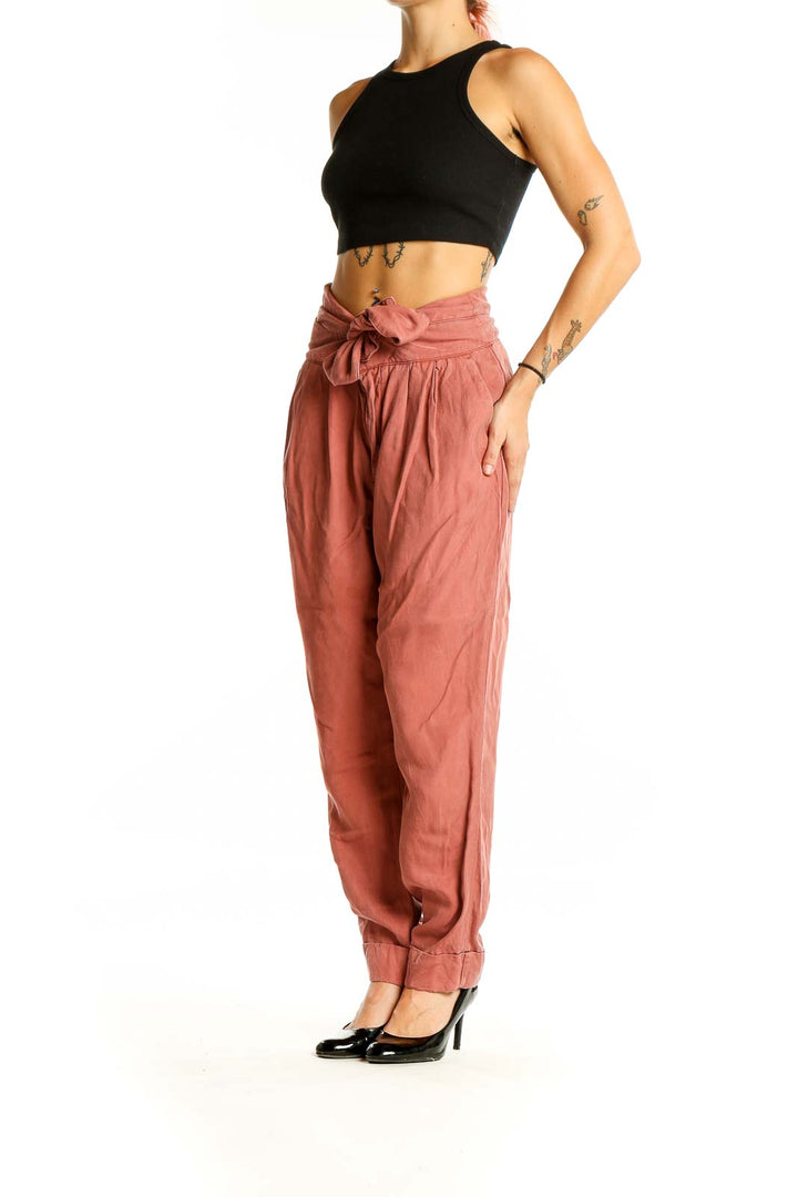 Front view of Cartonnier terracotta high-waisted pants with tie-front detail