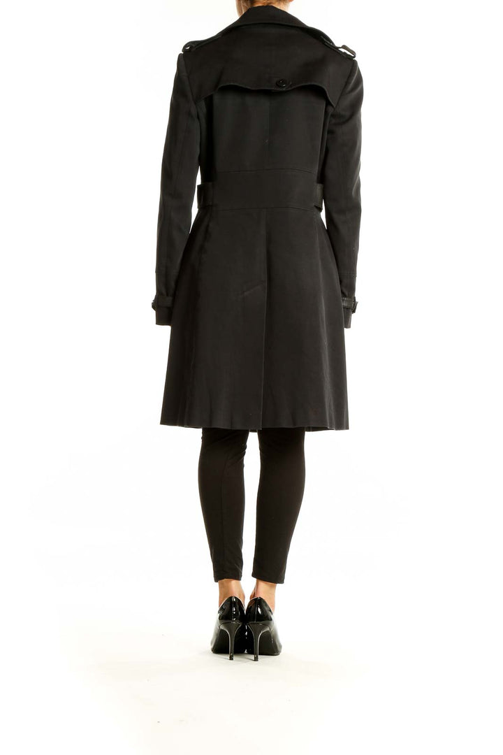 Back view of Karen Millen black trench coat showing storm flap and length