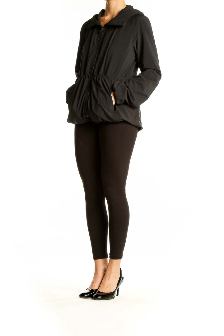 Front view of black Lululemon zip-up hooded jacket with cinched waist