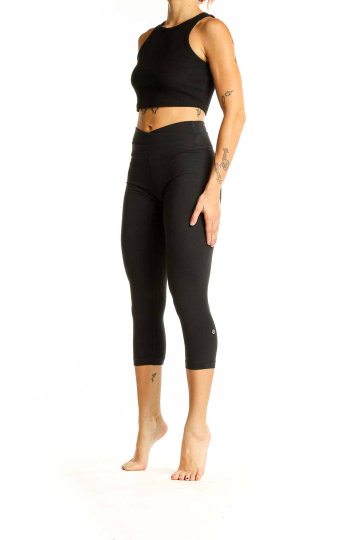 Front view of black Lululemon high-waisted cropped activewear leggings