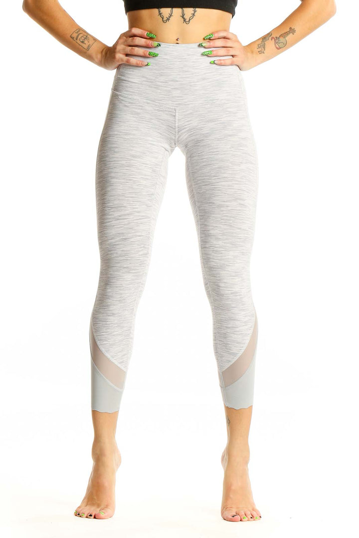 Front view of Lululemon light gray high-waisted cropped leggings with mesh inserts