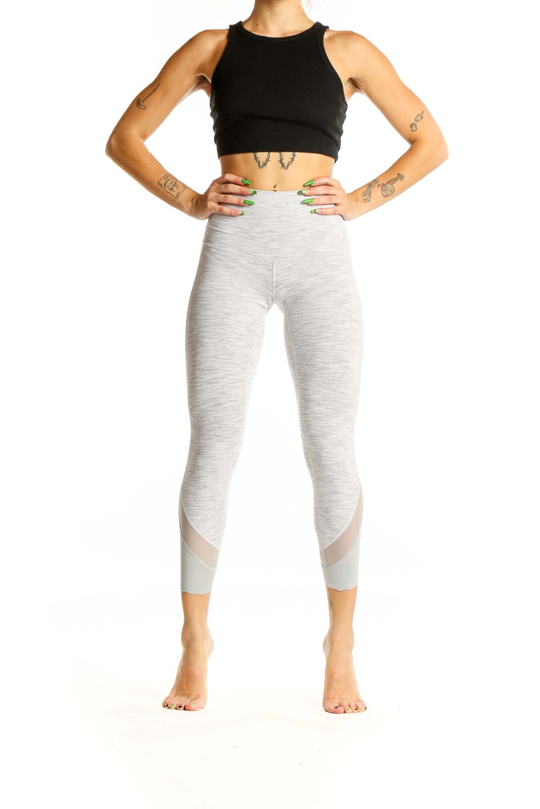 Front view of Lululemon light gray high-waisted cropped leggings with mesh inserts