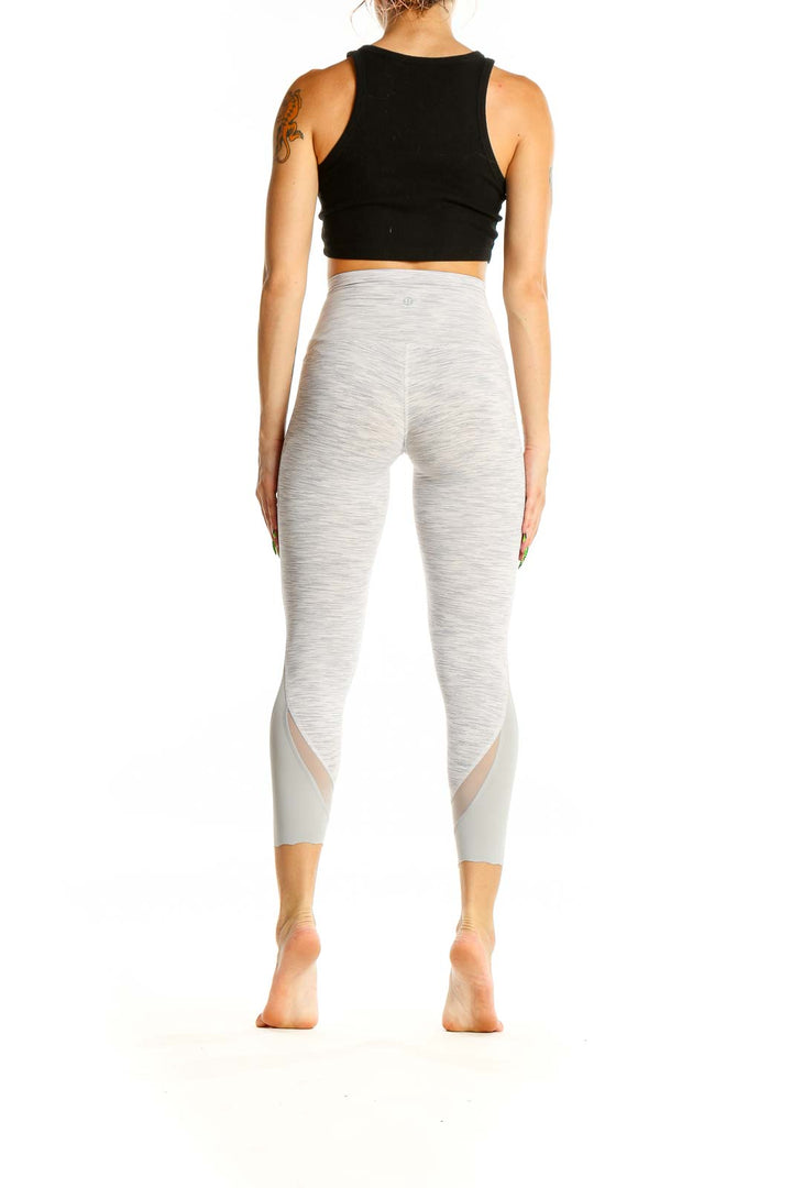 Back view of Lululemon light gray high-waisted cropped leggings showing fit and design