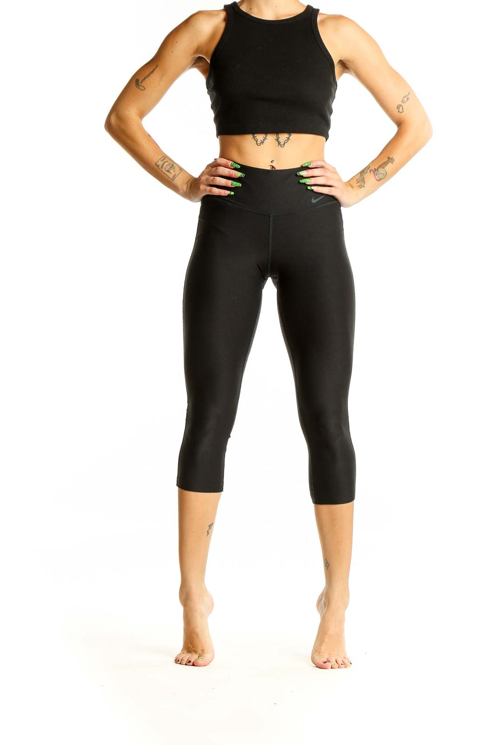 Front view of black Nike high-waisted capri leggings on model