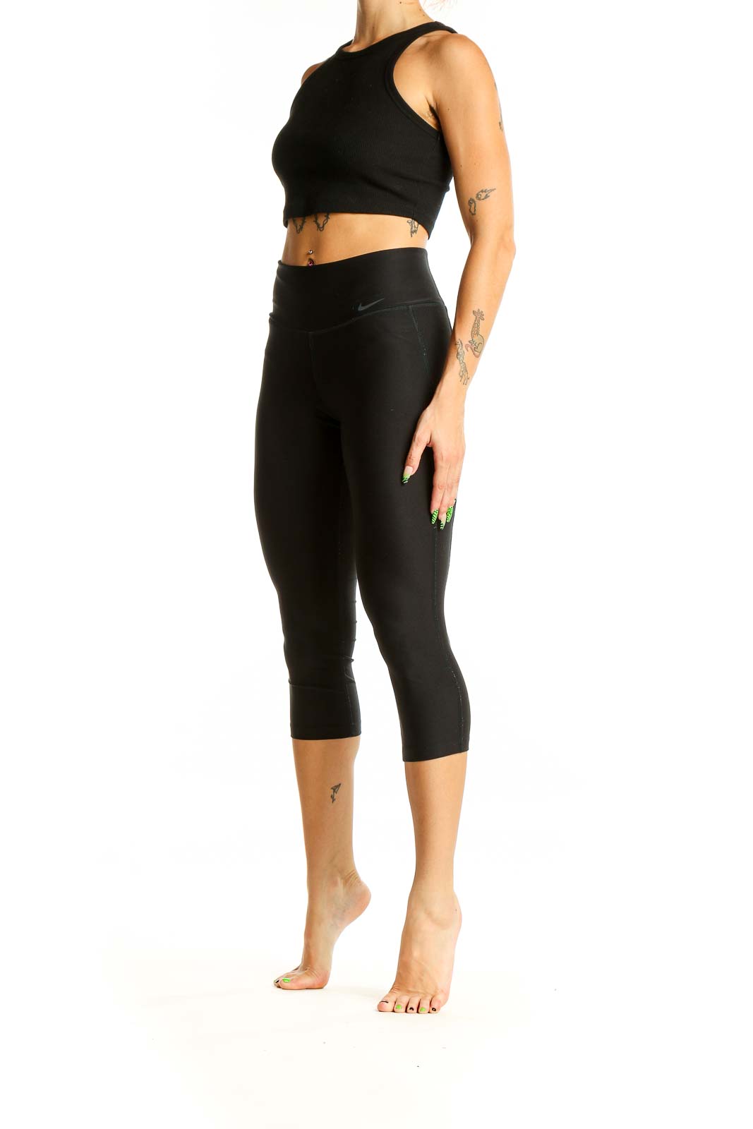 Front view of black Nike high-waisted capri leggings on model