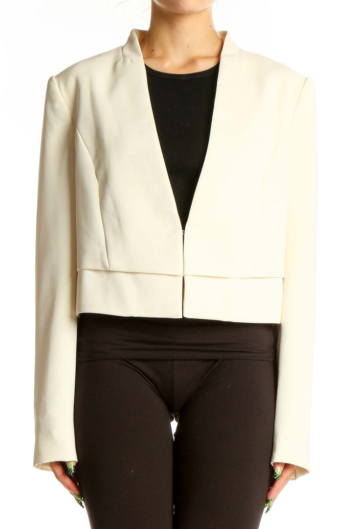 Front view of White House Black Market ivory cropped open-front jacket