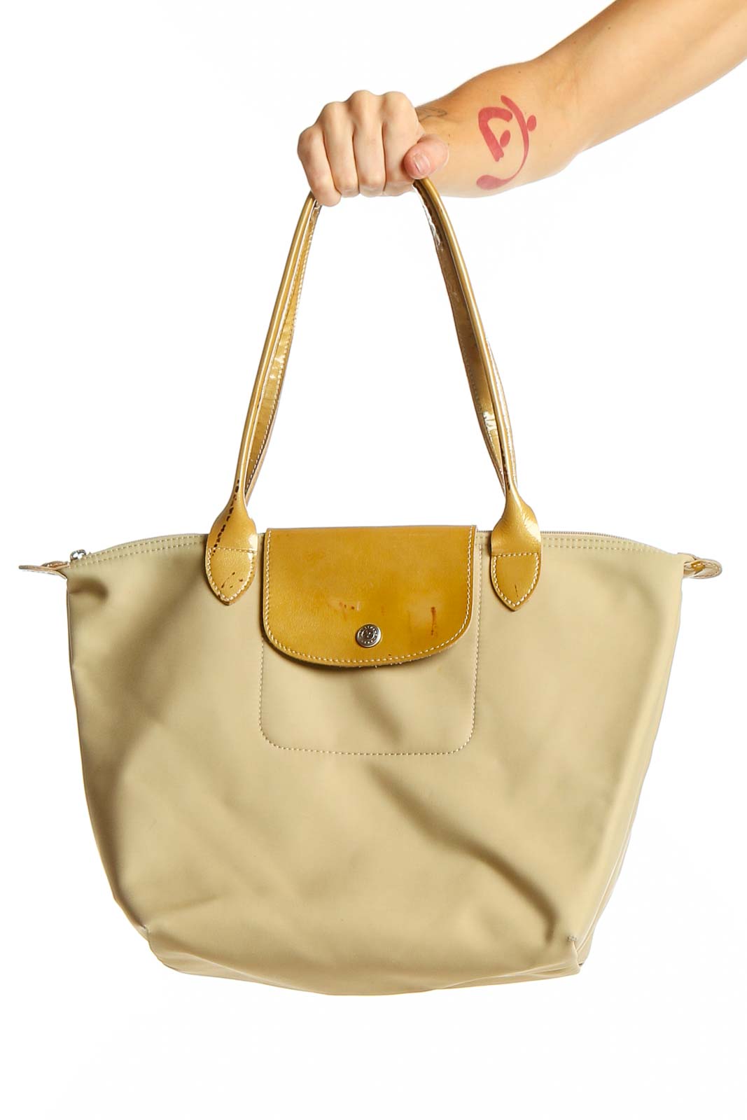 Front view of Longchamp beige and yellow tote bag held by hand