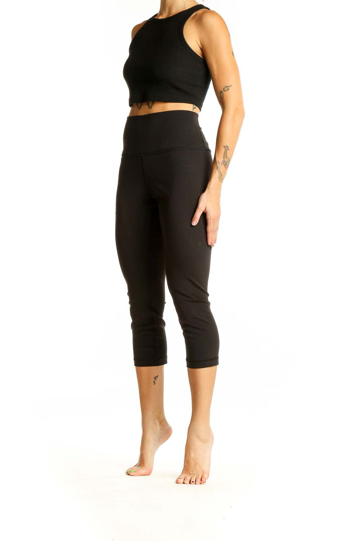 Front view of black Lululemon high-waisted capri leggings