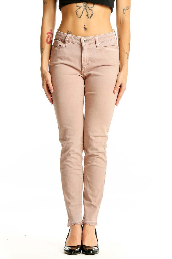 Front view of Lucky Brand blush pink slim fit jeans on model