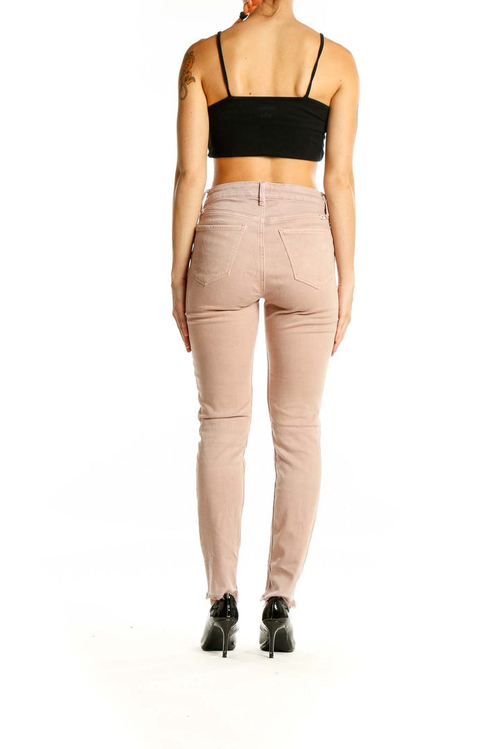 Back view of Lucky Brand blush pink slim fit jeans on model